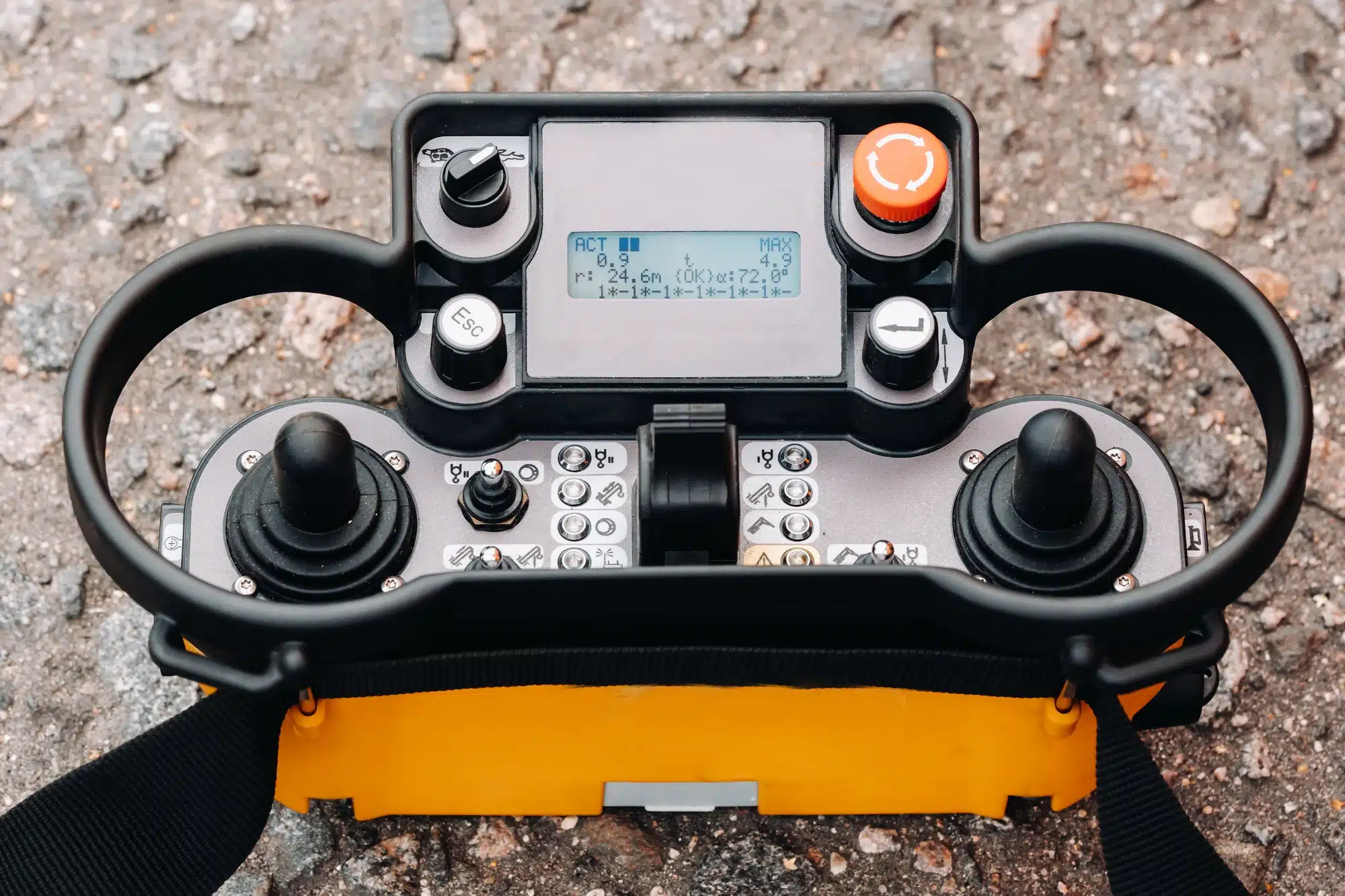 Remote control of a lifting car crane. Panel with joysticks and buttons for controlling the